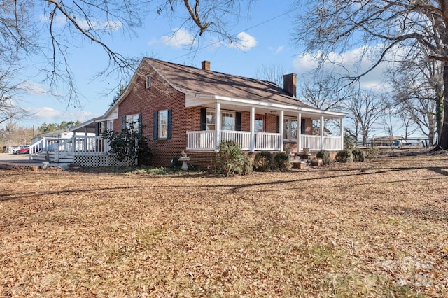 view of front of property with covered porch and a front yard