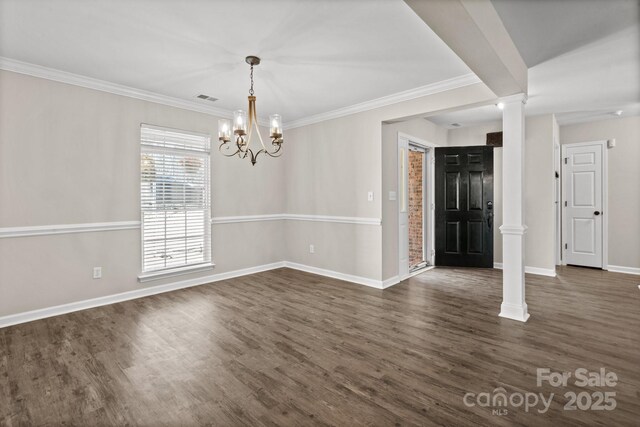 unfurnished dining area with crown molding, dark wood finished floors, ornate columns, visible vents, and baseboards