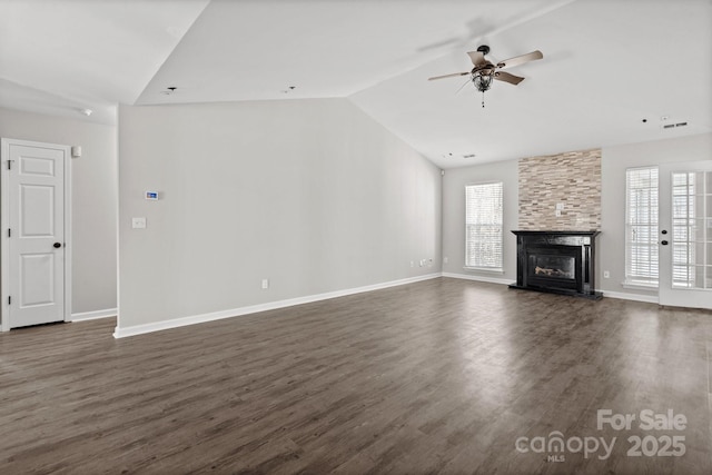 unfurnished living room with a fireplace, a ceiling fan, vaulted ceiling, and dark wood finished floors