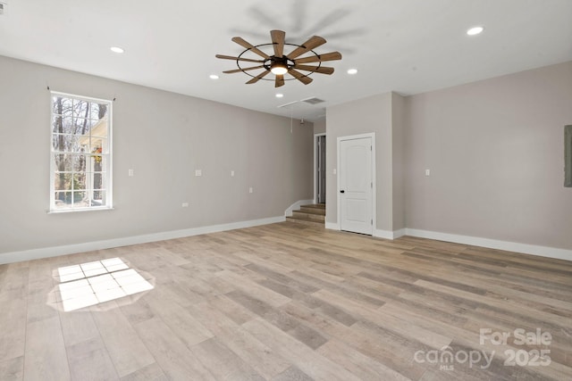 spare room featuring attic access, recessed lighting, baseboards, and light wood finished floors