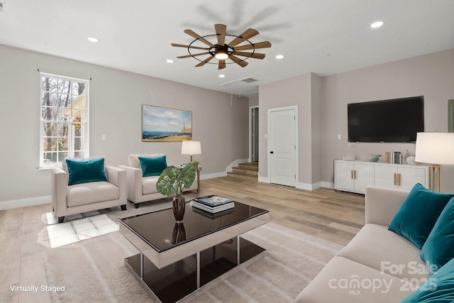 living area with attic access, recessed lighting, and light wood-type flooring