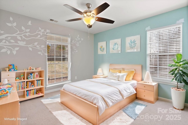 bedroom featuring baseboards, visible vents, ceiling fan, and light colored carpet