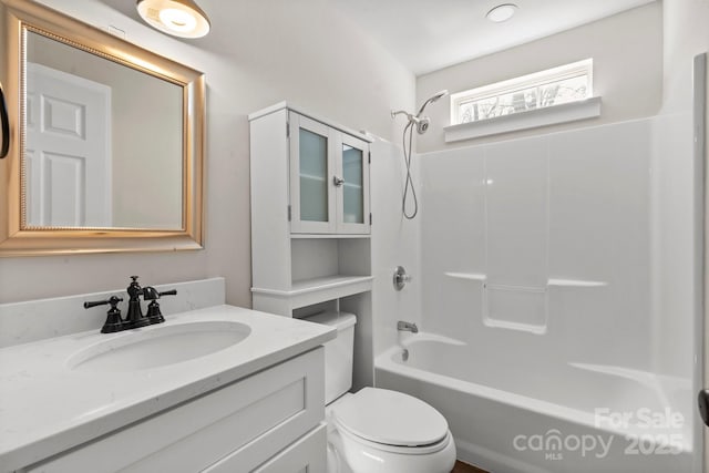 bathroom with toilet, tub / shower combination, and vanity