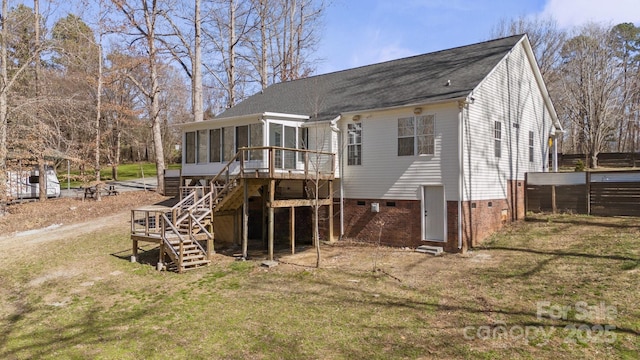 back of house with a sunroom, a yard, a deck, and stairs