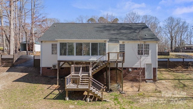 back of property featuring roof with shingles, a lawn, stairway, a sunroom, and crawl space