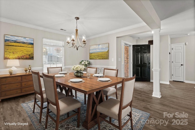 dining area featuring dark wood-style flooring, a notable chandelier, visible vents, and ornate columns