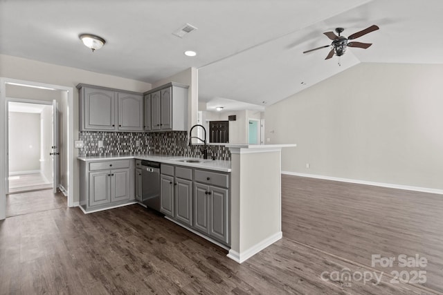 kitchen with gray cabinets, a peninsula, a ceiling fan, dishwasher, and a sink