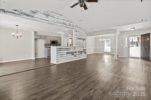 888 Brevard Place Rd, Iron Station, NC 28080 - unfurnished living room featuring a chandelier, a ceiling fan, dark wood-type flooring, baseboards, and high vaulted ceiling