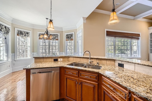 kitchen featuring sink, light stone counters, hanging light fixtures, and stainless steel dishwasher