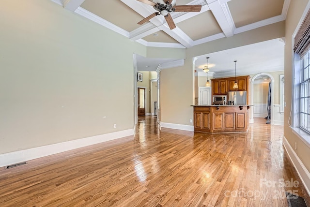 unfurnished living room featuring light hardwood / wood-style floors, coffered ceiling, ornamental molding, beam ceiling, and ceiling fan