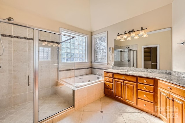 bathroom featuring independent shower and bath, tile patterned floors, and vanity