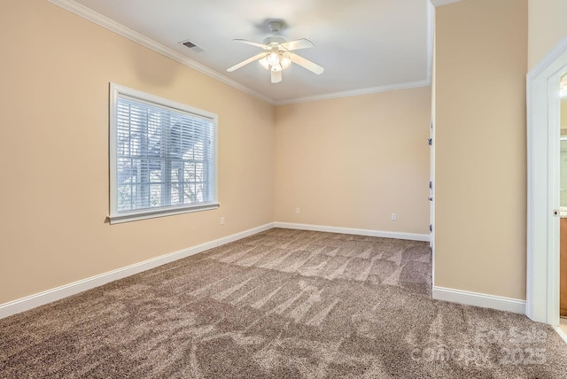 spare room featuring ceiling fan, carpet, and crown molding