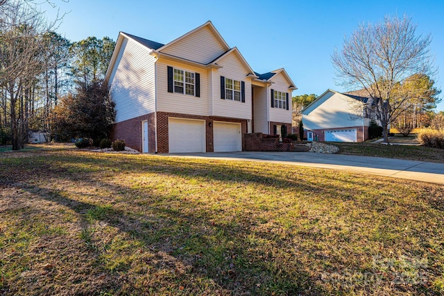 view of front of house with a garage and a front lawn