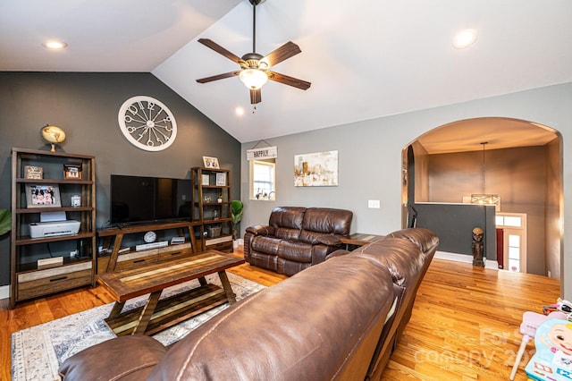 living room featuring ceiling fan, hardwood / wood-style floors, and lofted ceiling