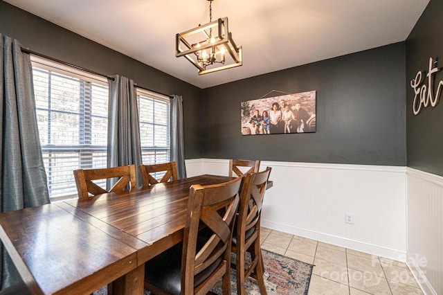 dining area with light tile patterned floors and a notable chandelier