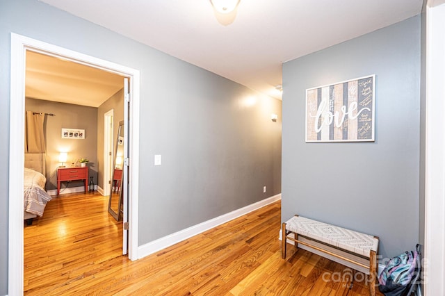 corridor with light hardwood / wood-style flooring