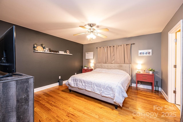 bedroom with ceiling fan and hardwood / wood-style flooring