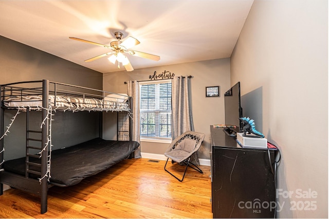 bedroom with ceiling fan and hardwood / wood-style floors