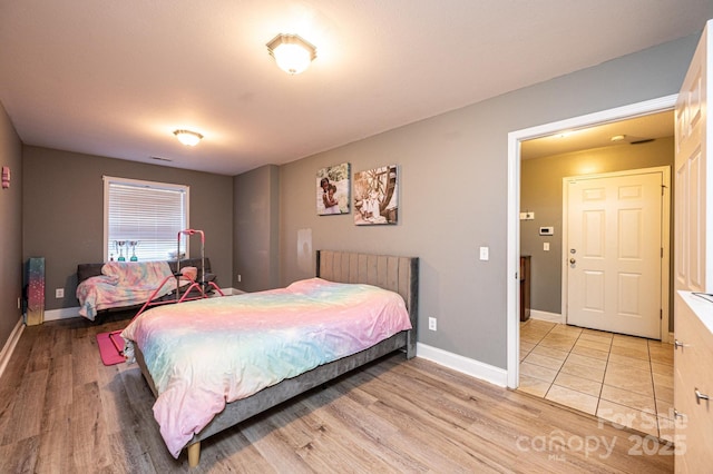 bedroom with light hardwood / wood-style flooring