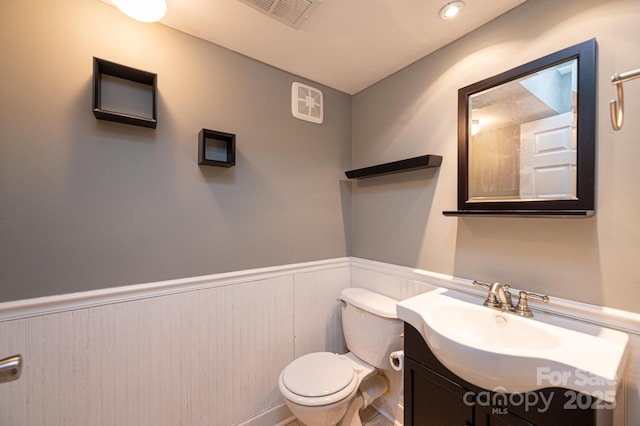 bathroom featuring vanity and toilet