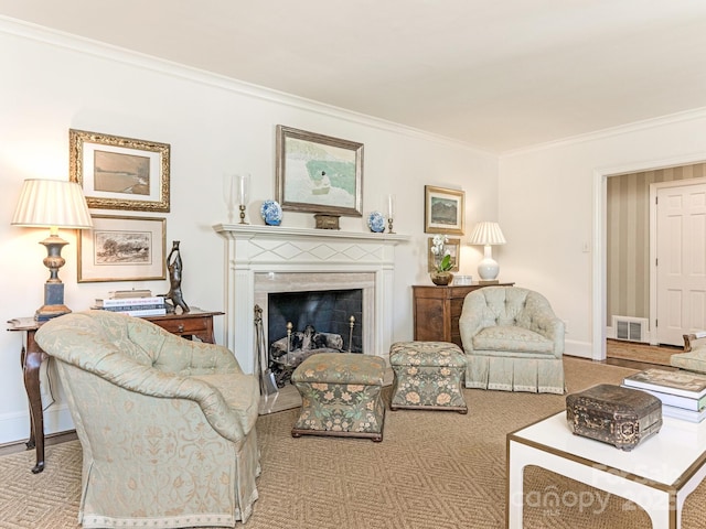 carpeted living area featuring baseboards, a fireplace, visible vents, and ornamental molding