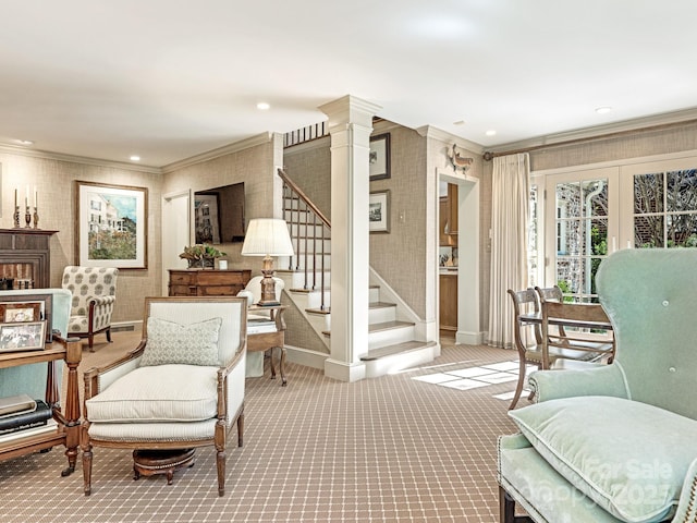 living area featuring carpet floors, wallpapered walls, stairs, and crown molding