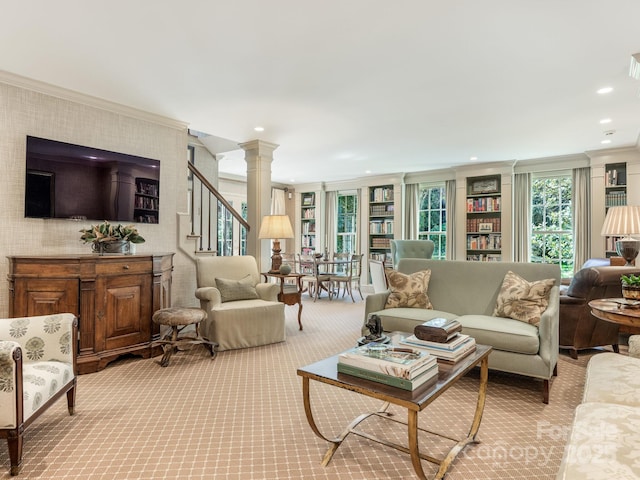 living area with decorative columns, ornamental molding, stairs, carpet flooring, and recessed lighting