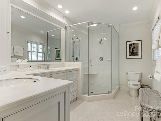 full bathroom featuring a stall shower, crown molding, toilet, and tile patterned floors