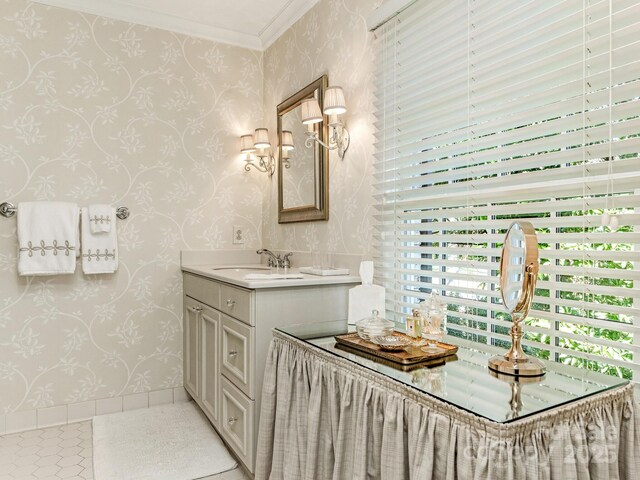 bathroom featuring ornamental molding, vanity, tile patterned flooring, baseboards, and wallpapered walls