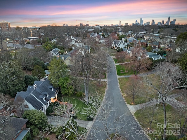 aerial view at dusk featuring a view of city