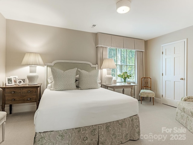 bedroom with light carpet, visible vents, and baseboards