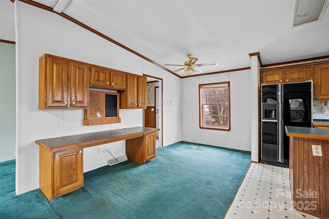 kitchen with lofted ceiling, black fridge with ice dispenser, crown molding, built in desk, and ceiling fan