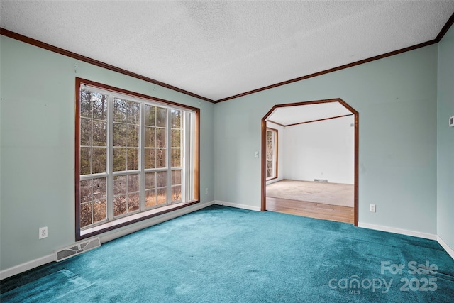 unfurnished room featuring crown molding, carpet flooring, and a textured ceiling