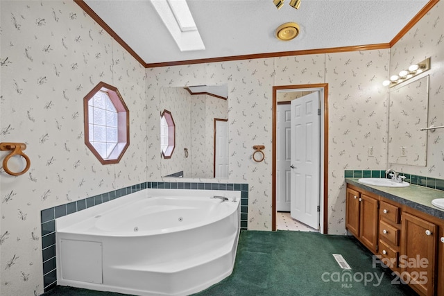 bathroom featuring ornamental molding, lofted ceiling with skylight, vanity, and a bathtub