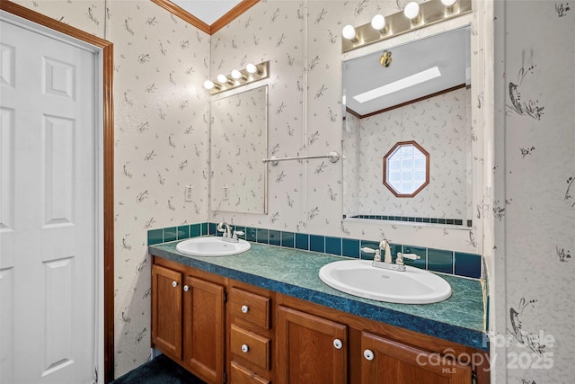 bathroom with ornamental molding and vanity