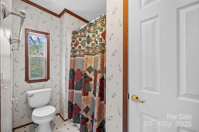 bathroom with crown molding, a textured ceiling, toilet, and walk in shower