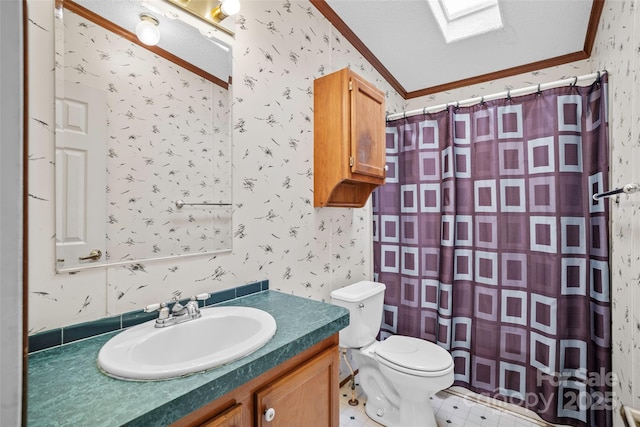 bathroom with vanity, a skylight, ornamental molding, and toilet