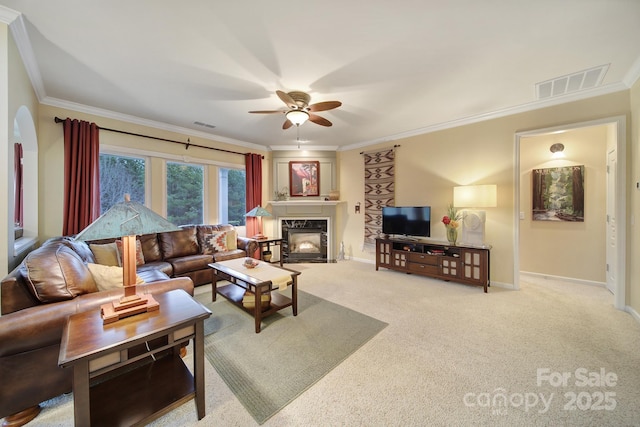 living room featuring light colored carpet, ornamental molding, and ceiling fan