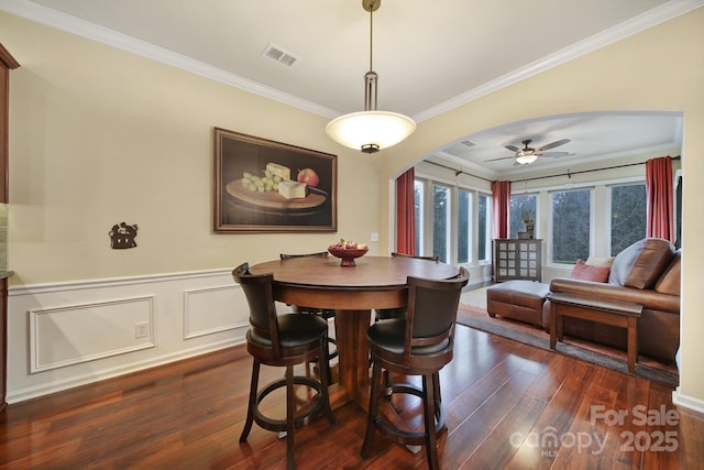 dining space featuring ornamental molding, dark hardwood / wood-style floors, and ceiling fan