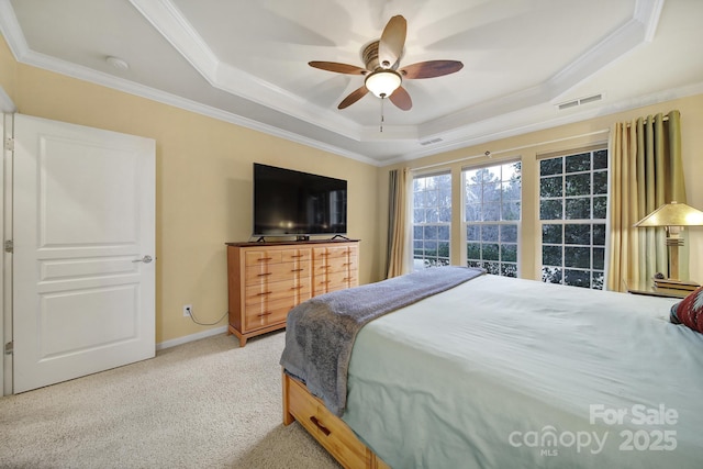 bedroom with a raised ceiling, ornamental molding, carpet floors, and ceiling fan