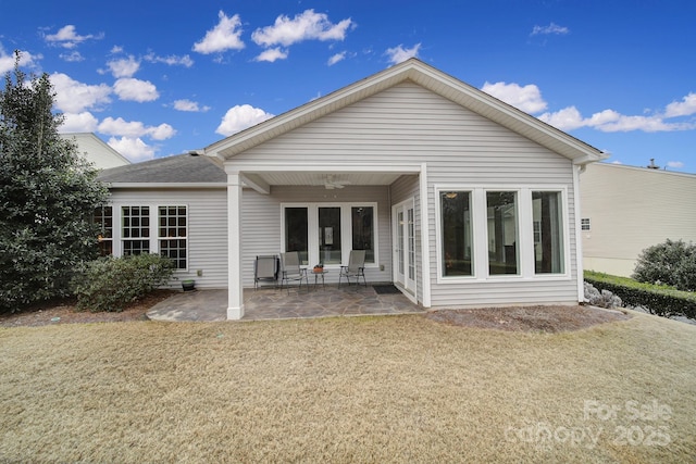 back of house featuring a yard and a patio area