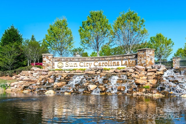 community / neighborhood sign with a water view