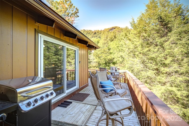 wooden terrace featuring area for grilling