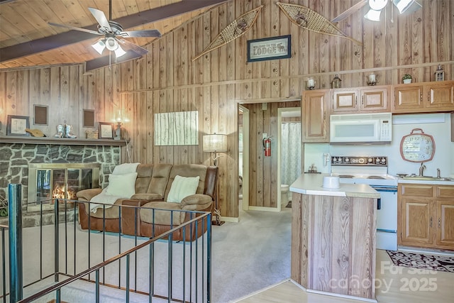 kitchen with ceiling fan, wooden walls, and white appliances