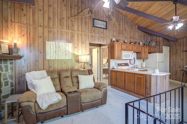 carpeted living room featuring ceiling fan, beamed ceiling, wood walls, and wooden ceiling