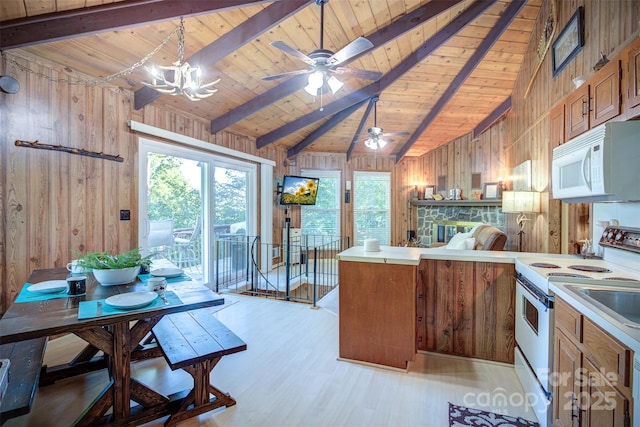 kitchen featuring white appliances, wood ceiling, decorative light fixtures, wood walls, and lofted ceiling with beams