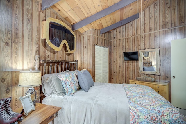 bedroom featuring a closet, wood walls, wood ceiling, and vaulted ceiling with beams