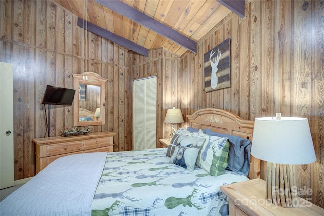 bedroom with a closet, lofted ceiling with beams, wood ceiling, and wooden walls