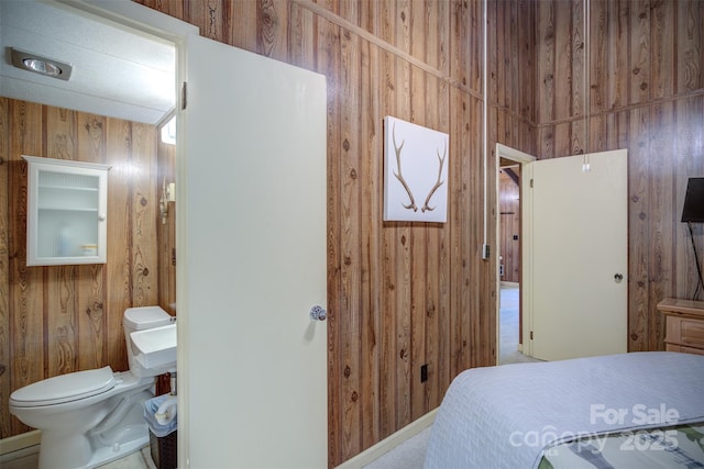 bedroom featuring wooden walls