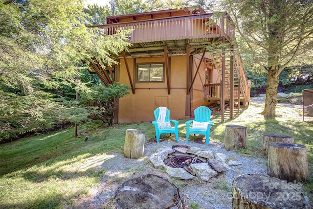 view of patio / terrace featuring a wooden deck and a fire pit